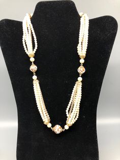 This is a beautiful 7 strand faux pearl necklace . the necklace is adjustable 20" - 22" long and has a nice faux pearl closure, the beads are plastic. within the 6 strands has a metal chain. the beads are resin, the necklace is in great shape. Made in Japan nice pre owned, estate sale find. Measures 2o"-22" Email me with any questions Luxury Vintage Single Strand Beaded Necklace, Formal Adjustable Multi-strand Necklace, Adjustable Multi-strand Pearl Beaded Necklace, Formal Multi-strand Beaded Pearl Necklace, Vintage Multi-strand Pearl Necklace For Formal Occasions, Multi-strand Pearl Drop Necklace, Beaded Multi-strand Pearl Layered Necklace, Pearl Costume Jewelry Necklace, Adjustable Multi-strand Pearl Necklace