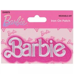 barbie iron - on patch with the word barbie in pink and white letters, sitting on top of a pink package