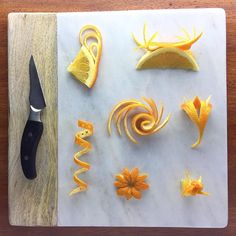 orange peels cut up and placed on a cutting board next to a pair of scissors