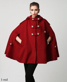 "This Wool cape is a gorgeous clothing with hood, design with hip pockets and large silver button details. This winter cape is made from soft wool fabric,the red wool cape is completely lined in polyester with fabulous flap detailing on the front, shoulders, pockets and back. This is a womens hooded cape you will wear forever. The stylish design will gives a retro feeling and keep you warm in winter days.put it on, you will be the focus of everyone's attention. Detail * The coat is the perfect g Red Cape Coat, Mantel Cape, Princess Cape, Winter Cape, Wool Cape Coat, Outerwear Women Winter, Clothing Studio, Tailored Clothes, Handmade Skirts