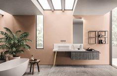 a bathroom with a sink, mirror and bathtub next to a potted plant