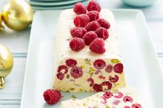 a piece of cake with raspberries on it