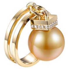 Unveil the epitome of elegance with this luxurious ring, masterfully crafted to spotlight a resplendent 12mm Gold South Sea pearl. The golden hue of the pearl harmoniously melds with the warm embrace of its 18 karat yellow gold setting. Enhancing its grandeur, 0.17 carats of meticulously selected round cut diamonds accent the pearl, adding a shimmering contrast that's both delicate and captivating. This ring isn't just an accessory, but a statement—a blend of nature's splendor and artisan crafts Luxury Yellow Gold Pearl Ring, Luxury Pearl Ring For Evening, Luxury High Luster Pearl Ring For Formal Occasions, Luxury Gold Pearl Ring With High Luster, Formal Yellow Gold Pearl Ring With High Luster, Luxury High Luster Gold Pearl Ring, Formal High Luster Yellow Gold Pearl Ring, Elegant Gold Pearl Ring With High Luster, Elegant Yellow Gold Rings With High Luster