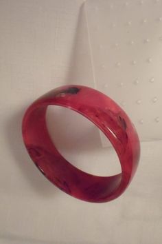 "Measuring 7/8\" wide with an inside diameter of 2-5/8\", this bracelet is made from really excellent Lucite in Italy. Colored in luscious lipstick red and marbled with black and white design. Add this great piece to your collection that is in excellent vintage condition. Note the original gold \"Made in Italy\" label on the interior!" Hip Jewelry, Pink Jewelry Set, Mod Jewelry, Gold Scarf, Black Bangle, Paired Jewelry, Yellow Bracelet, Lipstick Red, Red Jewelry