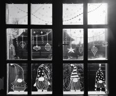 black and white photograph of christmas decorations through a window