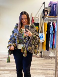 Our wool ponchos are Unisex. Hand woven by Indigenous women in Mexico. Can be used as a poncho shawl, lap blanket or wall decor!  Each piece is one of a kind, combined with colorful pompoms and tassels on each corner with ties to the front. -100% sheep wool, yarn pompoms -Size: 30x60 inches, can vary slightly  -Handwash, dry flat Bohemian Woven Winter Shawl, Handwoven One-size Shawl For Fall, Handwoven Shawl For Fall, One Size, Bohemian Alpaca Shawl One Size, Hippie Shawl One Size For Fall, Hippie Shawl For Fall, Hippie Shawl For Fall, One Size, Multicolor Tassel Shawl For Fall, Hippie Poncho For Fall