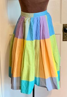 "This is a skirt from the late 50's. It is a very tiny, petite size.  Theoretically one who sews could replace the waist band and stretch out the pleats to enlarge .  The skirt is a cotton fabric with blocks of light and vibrant colors. The tag says \"Belle\" and that it is a vintage size 5. It is a small or petite size.  Skirt closes with a metal zipper and a button.  Condition is good, with no tears or noticeable stains. Garment has been laundered and steamed.  Measurements when laid flat:   W Pastel Skirt, Klamath Falls, Dopamine Dressing, Study Photos, Sunset Colors, Vintage Fabrics, Metal Zipper, Petite Size, Fabric Decor