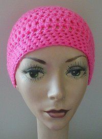 a mannequin head wearing a pink crochet hat