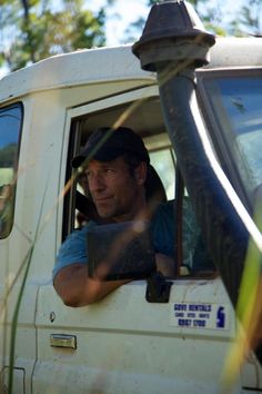 a man sitting in the driver's seat of a truck