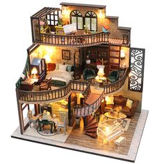 a doll house is shown with furniture and lights on the top floor as well as stairs