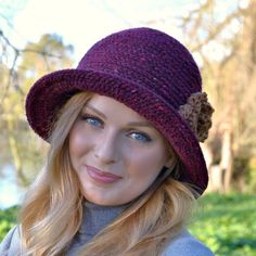 a woman with blonde hair wearing a purple hat