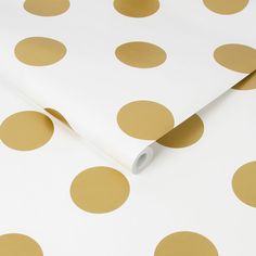 a white and gold polka dot wrapping paper