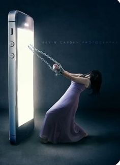 a woman in a purple dress is chained to a cell phone with chains around her