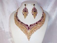 Purple rhinestone necklace and earrings set. Golden base for beautiful purple crystal rhinestones. Returns & exchanges I ship five days a week, Monday through Friday, via USPS First Class Mail. You'll find the cost of domestic US shipping with each item's listing. Expedited Shipping If you need your item quickly, you can choose USPS Priority shipping or Express shipping at check out. I gladly accept cancellations Request a cancellation within: 1 hours of purchase I don't accept returns or exchan Cheap Purple Costume Jewelry Necklaces, Gold Necklace Set Bridal, Purple Necklace Set, Purple Statement Necklace, Statement Necklace Gold, Dance Necklace, Purple Necklace, African Print Dresses, Gold Necklace Set