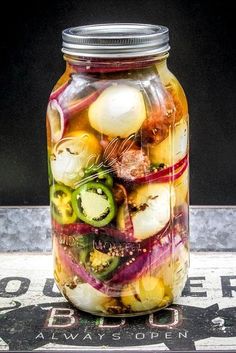 a jar filled with pickled vegetables sitting on top of a table