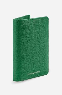 a green leather wallet with the name maison - marie written on it in white lettering