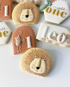 decorated cookies are arranged in the shape of animals and letters on top of each cookie