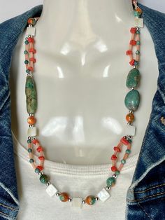 A blend of Genuine Sea Green Turquoise, Angel Skin Coral, Red Sponge Coral, Mother of Pearl, Rain Flower Jade and 925 Silver beads. A 925 Silver toggle for closing. The long Turquoise bead is 1 5/8" and the smaller ones are each 5/8". Total length of necklace is 24". No nickel or lead used. Please use the Last On, First Off approach. Stones discolor with lotions, perfumes, hairspray, sweat, chlorine, even some soaps, and will break if dropped. Bohemian Coral Necklaces With Natural Stones, Bohemian Coral Beaded Necklace, Bohemian Coral Necklace With Natural Stones, Multicolor Bohemian Long Turquoise Necklace, Handmade Coral Beaded Bohemian Necklace, Bohemian Coral Beaded Necklaces With Large Beads, Handmade Coral Bohemian Beaded Necklaces, Bohemian Coral Gemstone Beads, Bohemian Coral Beaded Necklace With Large Beads