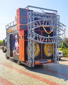 an orange and black truck with some pictures on it's side