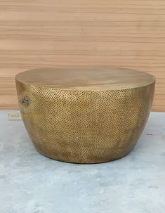 a large round gold table with holes in the middle