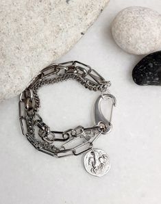 "Multi bold chains coin charm bracelet, safety pin ancient greek round coin hook chunky cuff, silver statement rock style layered bracelet. It is a modern antique silver stainless steel chain bracelet, that you can wear it as it is or mix it with other bracelets for a punk rock style! The metal parts are brass metal. They have been immersed into pure silver twice so that they contain sterling silver! All silver pieces are subjected to an anti-allergic process ( nickel and lead-free. HOW TO MEASU Trendy Metal Paperclip Jewelry, Trendy Paperclip Shaped Metal Jewelry, Silver Jewelry With Chunky Paperclip Chain, Everyday Silver Coin Jewelry, Coin Charm Bracelet, Layered Bracelet, Punk Rock Fashion, Modern And Antique, Layered Bracelets