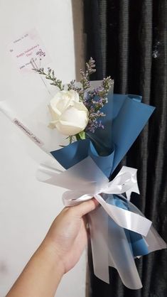 a person holding a bouquet of flowers in their hand