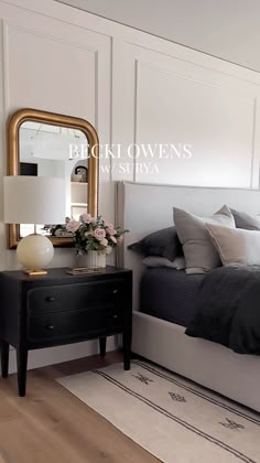 a bedroom with a bed, dresser and mirror in it's centerpieces