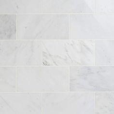 a white marble tile wall that looks like it has been cleaned