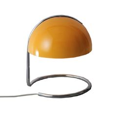 an orange lamp with a metal base and a white light bulb on it's side