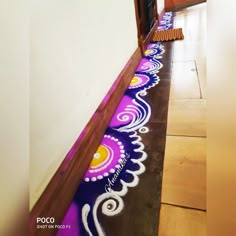 the floor is decorated with purple and yellow designs, along with white paint on it