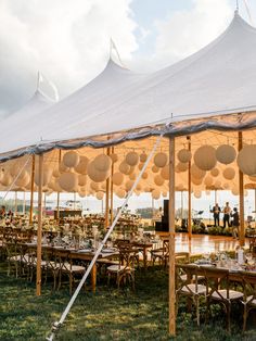 a large tent set up with tables and chairs