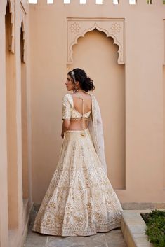 Ivory raw silk lehenga with finest kundan and zardozi embellishments , paired with elbow sleeve embroidered blouse and organza zardozi and pearl work dupatta.From Chamee and Palak's The Romantics collection.DELIVERY TIMEPlease allow 8-12 weeks for your outfit to arrive.FABRIC DETAILSRaw Silk, OrganzaProfessional cleaning only. Elegant Off-white Lehenga For Festive Occasions, Elegant Cream Lehenga For Navratri, Silk Lehenga With Cutdana For Reception, Traditional Off White Gown For Designer Wear, Traditional Off White Designer Gown, Traditional Off-white Gown For Designer Wear, Traditional Off-white Designer Gown, Elegant Off White Choli With Resham Embroidery, Off White Sets With Dupatta For Reception