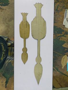 two pieces of wood cut out to look like clocks