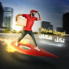 a man standing on top of a red object in the middle of a road with fire coming out of it