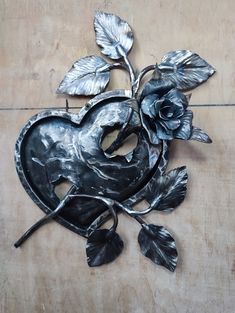 a metal apple with leaves and a flower