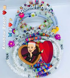 a bunch of bracelets with an image of a woman on one side and beads around the other