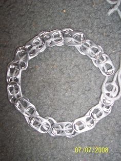 a silver chain bracelet on the ground