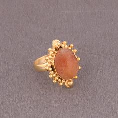 Wholesale Natural Sunstone Jewelry Supplier, Stylish Gold Plated Brass Ring, Orange Crystal Ring, Designer Fashion Ring Product Details Item Code: BJBR-2479 Stone Name: Sunstone Stone Shape : Oval Stone Size : 12*16mm Metal: 18K Yellow Gold Over Brass Ring Sizes: Please choose from drop down menu. If you do not see your finger size, select custom and I'll make a ring just for you!  Note :- This rings you will receive may vary slightly in color from the images because these are natural gemstones Orange Carnelian Ring Jewelry, Sunstone Gemstone Jewelry For Jewelry Making, Sunstone Gemstone For Jewelry Making, Unique Orange Ring Jewelry, Orange Open Ring Jewelry As Gift, Orange Open Ring Jewelry For Gift, Unique Orange Cabochon Ring, Bohemian Orange Jewelry Ring, Orange Gemstone-accented Ring Jewelry