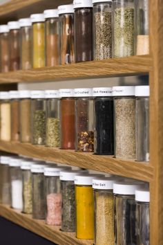 the shelves are filled with different types of spices