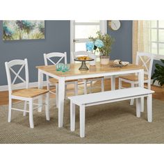 a dining room table with four chairs and a bench