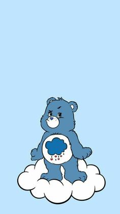 a blue teddy bear sitting on top of a cloud