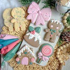 some decorated cookies are sitting on a wicker basket next to pine cones and other decorations