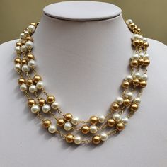 This beautiful white and golden pearl multistrand necklace and earring set is perfect for bridesmaids jewellery! or Valentine gift! Necklace : I have made it with 8 mm white and golden glass pearl beads. 2 pearls are looped together to form the beaded chain. There are 3 such beaded chains arranged in layers where they fall close to each other.Finished with beautiful antique gold finish chandelier connectors and lobster claw clasp. Length of the necklace is 17 inches with shortest strand and 19 i Pearl Layered Necklace, Chain Jewellery, Pearl Jewelry Set, Golden Pearl, Jewellery Wedding, Gift Sets For Her, Diy Bracelet Designs, Pearl Jewelry Sets, Bronze Jewelry