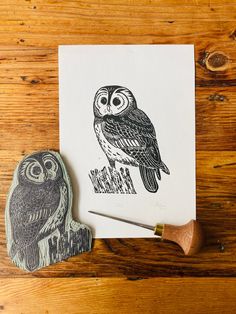 an owl stamp sitting next to a piece of wood