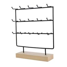 a black metal and wood display rack with six hooks on each side, holding several pairs of shoes