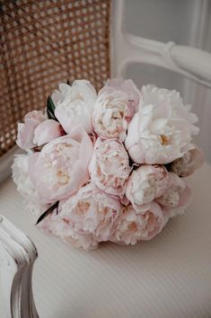 a bouquet of flowers sitting on top of a chair