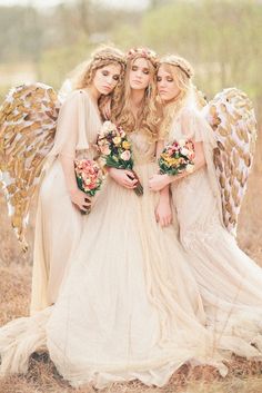 three beautiful women dressed in angel costumes