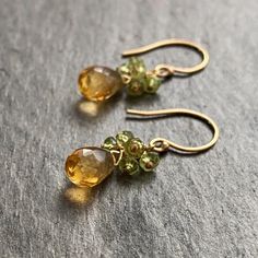 Yellow citrine and green peridot gemstone dangle earrings. These genuine yellow citrine gemstones are strung with the metal of your choice. Select 14k gold filled or sterling silver wire and chain from the drop down menu. They measure about 1 1/3 inches long x 3/16 inches wide. Yellow Citrine is a powerful gemstone which promotes joy and happiness, aids in digestion and increases abundance. It is the birthstone for November. Peridot promotes good health and good cheer and is the birthstone for August. Similar drop style earrings in my shop: https://www.etsy.com/shop/AzizaJewelry Your earrings will come with care instructions and wrapped in a box. Have questions? Concerns? I'd love to chat with you! ◊◊ Message me on Etsy convo here: https://www.etsy.com/conversations/new?with_id=7293349 OR Citrine Gemstone Jewelry For May Birthstone, Yellow Peridot Jewelry For May Birthstone, Fine Green Citrine Jewelry, Yellow May Birthstone Jewelry, Green Citrine Jewelry Gift, Green Citrine Jewelry For Gifts, Yellow Peridot Jewelry Gift, Faceted Citrine Dangle Jewelry, Yellow Peridot Birthstone Jewelry