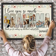 a woman holding up a framed photo with the words i love you so much grandma