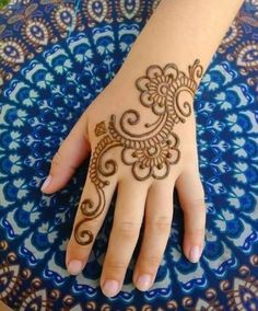 a person's hand with henna tattoos on it